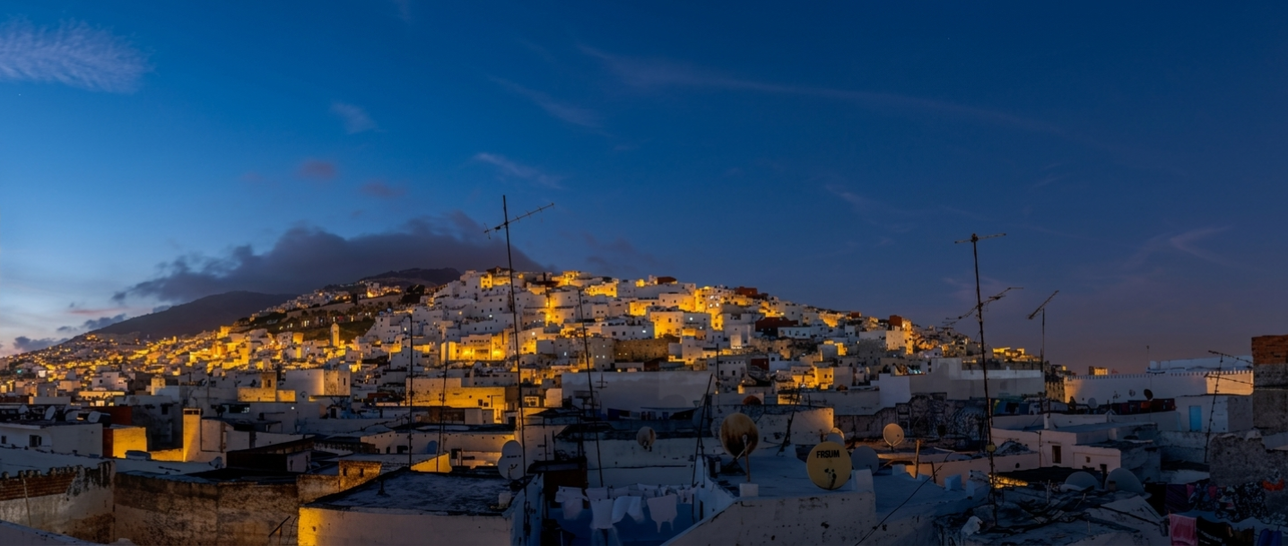 El Reducto — Panoramic night view of Tétouan's illuminated white Medina